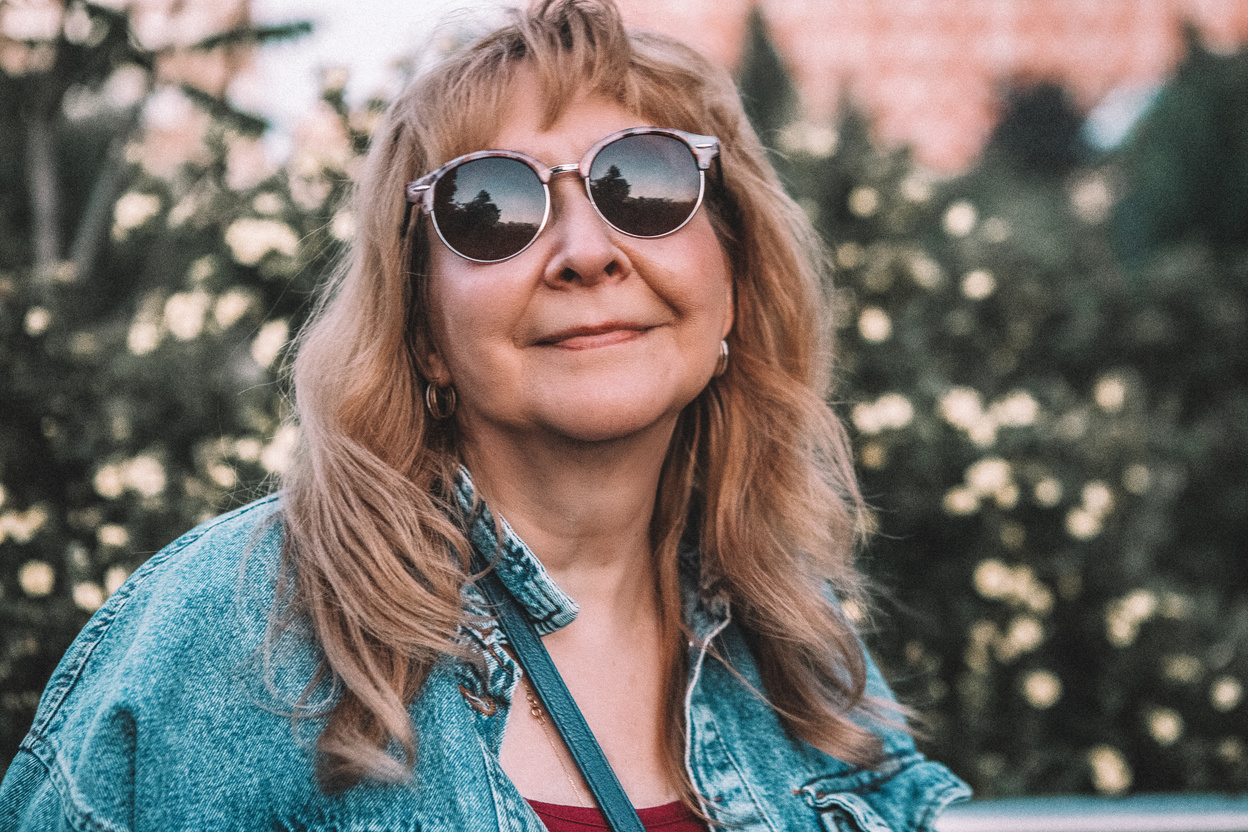 Portrait of Smiling Middle-Aged Woman in Sunglasses